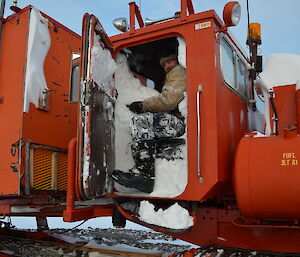 Jeremy Little in the cab of a loader which is filled with snow and ice