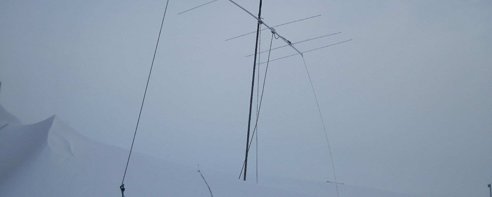 Antenna for moon bounce radio signal surrounded by piles of snow