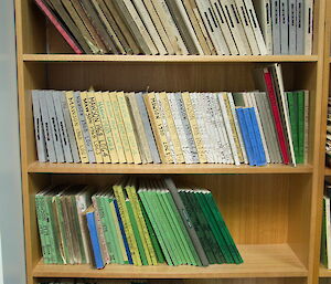 A book case filled with old log books