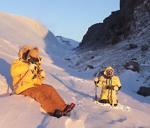 Lloyd and Craig take a break — sitting on an icy slope