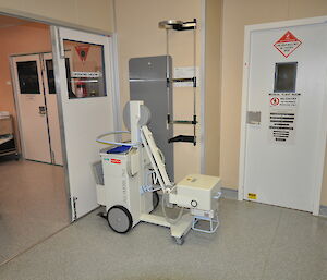 Mobile x-ray machine with wheels in a hallway