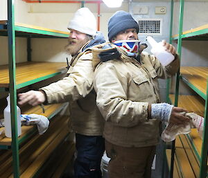Cliff and Jeremy cleaning a cold food storage area and are seen wiping empty shelves
