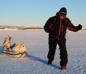 Cliff Simpson out on the ice, dragging a sled