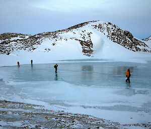 Expeditioners walking on the frozen lake