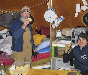 Geoff Brealey and Justin Chambers inside Beche hut smile for the camera