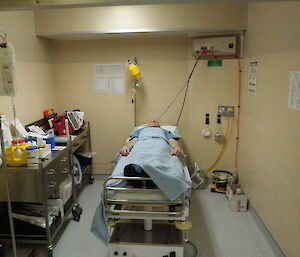 Medical training — a man lies in a hospital bed pretending to be a patient waiting for surgery
