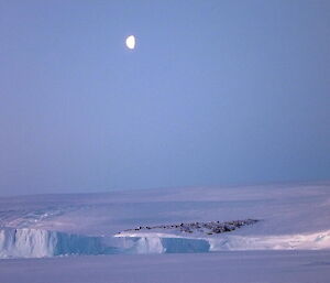Moonrise over an icy landscape