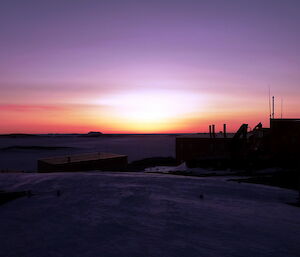 Sunset behind some buildings at Mawson