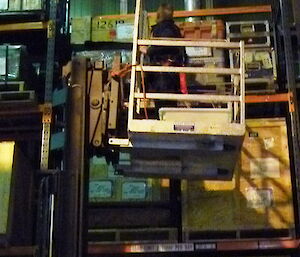 A man in a forklift organising storage
