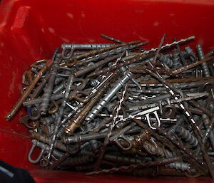 Ice screws in a large storage tub