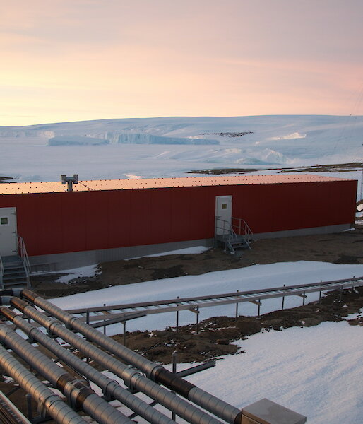 Mawson field store as seen from a distance, surrounded by snow