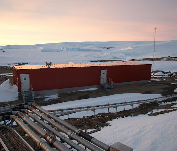 Mawson field store as seen from a distance, surrounded by snow