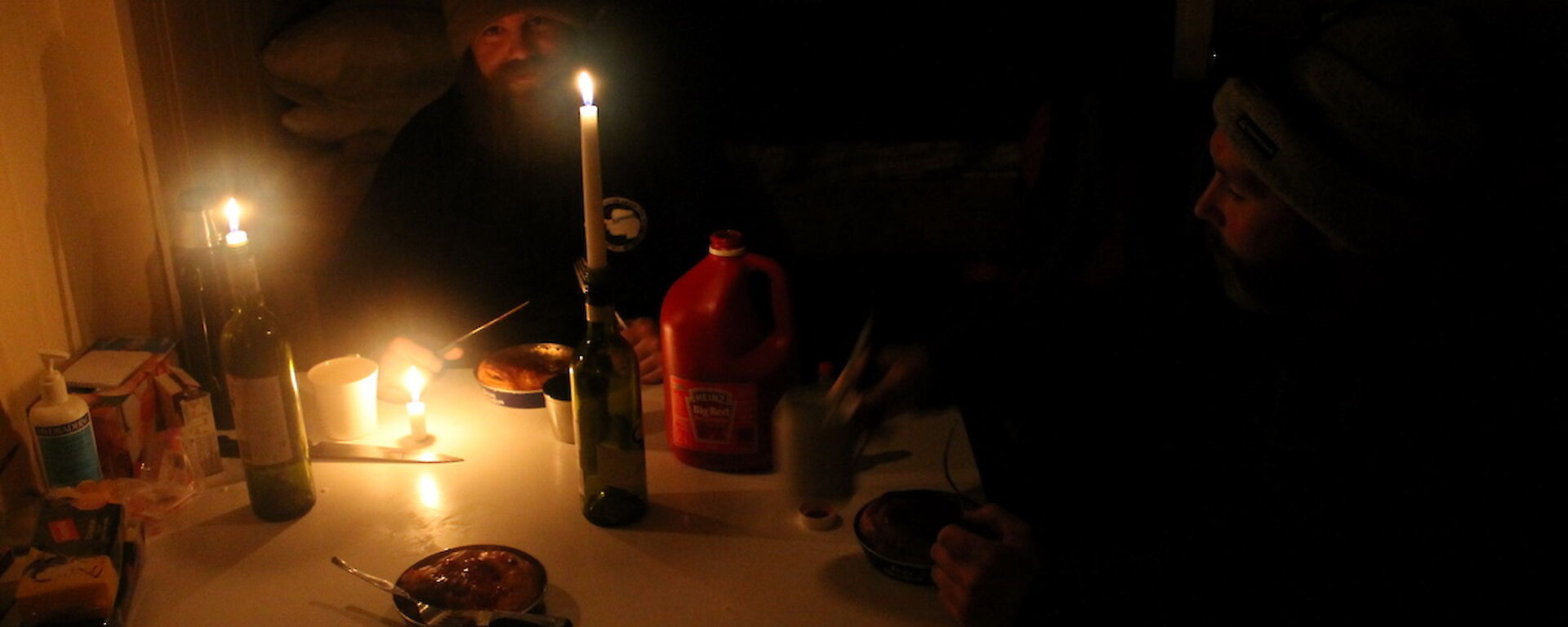 Dinner at field hut — Jeremy and Peter C tucking into freshly baked Fray bentos pies.