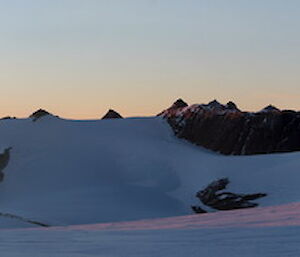 Two small hikers against a snowy panorama in the Southern Masson Range