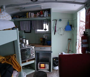 Inside Mt henderson hut with bookshelves and sitting spaces