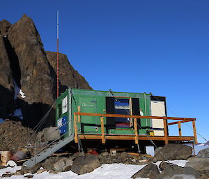 Rumdoodle Hut is green against a blue sky