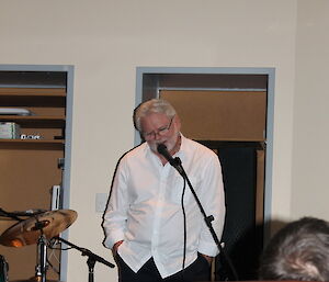 Station leader Graham Cook talkng into a microphone.
