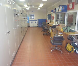 The inside of the Mawson Powerhouse with tiled floor and pipes.