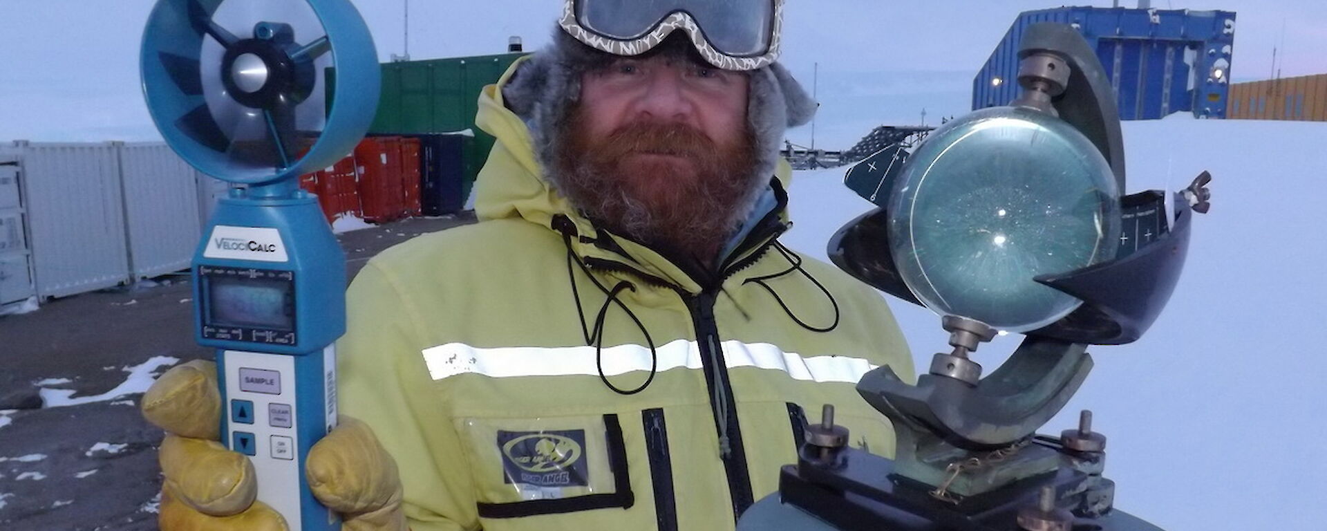 Craig Hayhow stading outside holding two different instruments.