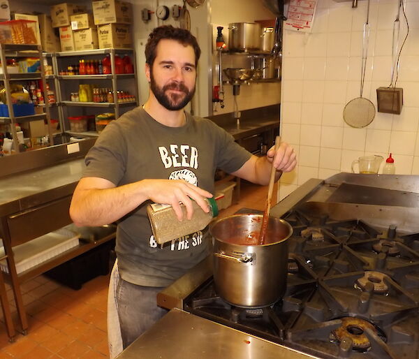 Trent pouring herbs into a pot.