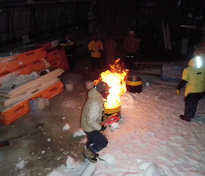 Expeditioner using a fire extinguisher with white smoke in plumes.