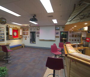 Mawson darts and bar area with notice boards and chairs.