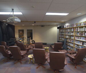 Mawson theatre with comfortable chairs and book shelves lining the walls.