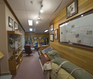 Mawson Dog Room has display cases and a sofa at the end with guitars propped there.