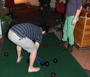Measuring the distance between bowls using a blue thong.