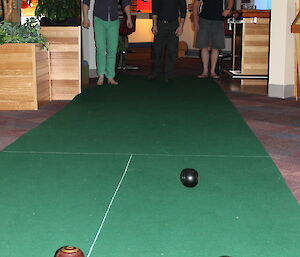 Three expeditioners watching the the plaement of the bowls which are closest to the camera.