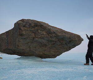 Huge boulder frozen into a precarious balancing positiion by ice.