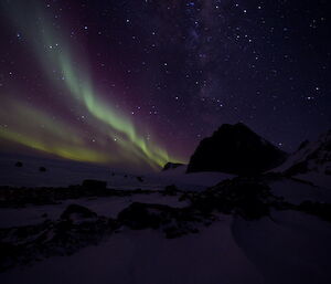 Aurora at Rumdoodle — greens streaks against a purple night sky.