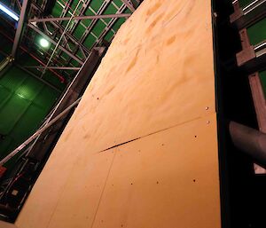 The plywood boards make a wall from floor to ceiling.