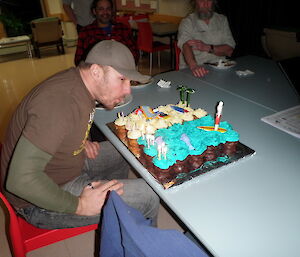 The chef blowing out candles on his birthday cake
