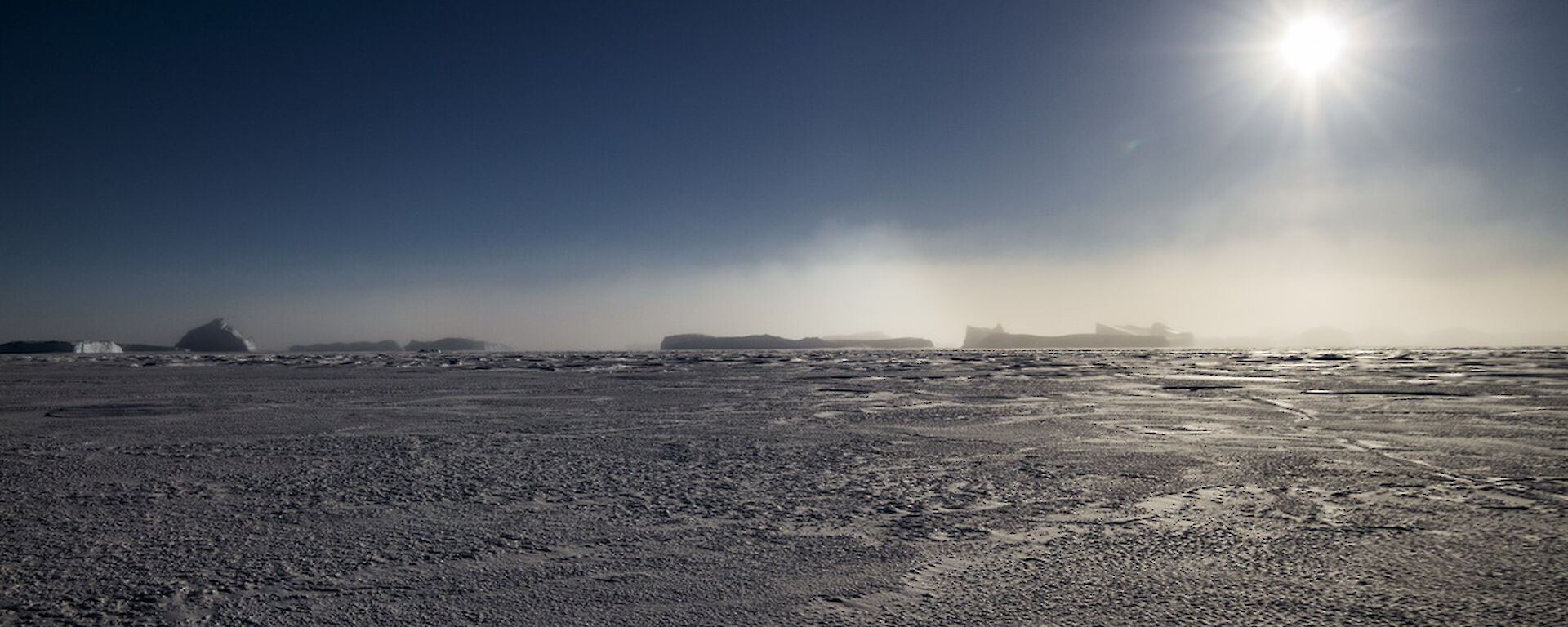 Diamond dust on the horizon over the ice.