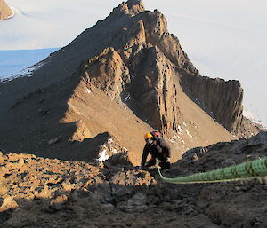 Keldyn approaching the summit with climbing rope in the foreground