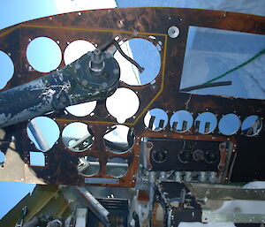 The cockpit of the aircraft with holes where the instruments were.