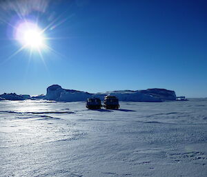 Cloudless sky with two quad bikes parked on the ice