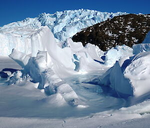 Rafted ice packed up against rocks