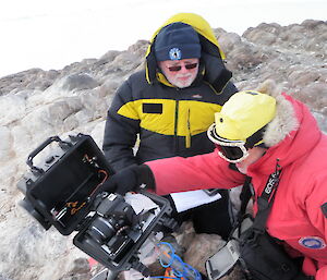 The Station leader and Field training Officer check out the penguin surveillance cameras.