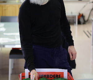 Daz stands behnd his Space Invader cake