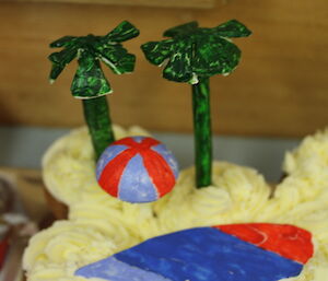 Cake with yellow icing and green palm trees