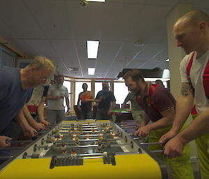 Expeditioners playing opposite each other in the tabletop football final