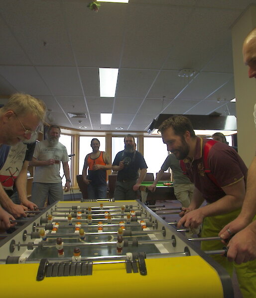 Expeditioners playing opposite each other in the tabletop football final