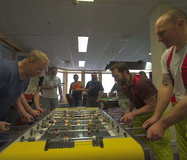 Expeditioners playing opposite each other in the tabletop football final