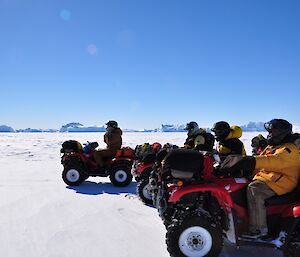 Expeditioners sitting on quad bikes all lined up in a row.