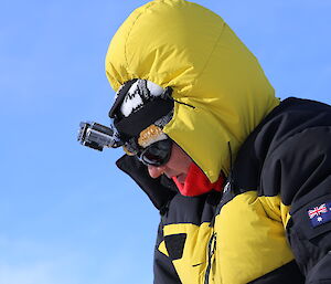 Barb Frankel wearing a hooded warmed jacket and head torch