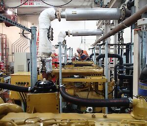 Blokes in the Powerhouse: a room full of pipes and tanks and instruments.