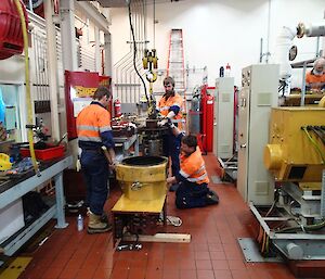 Three electricians diassembling the alternator