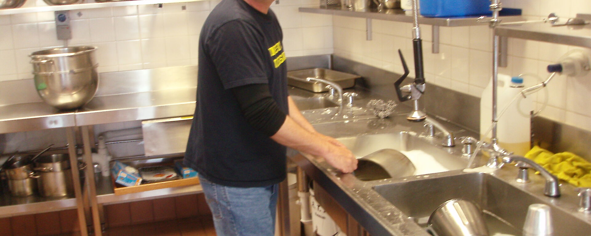 Dean in the kitchen at Mawson scrubbing pots